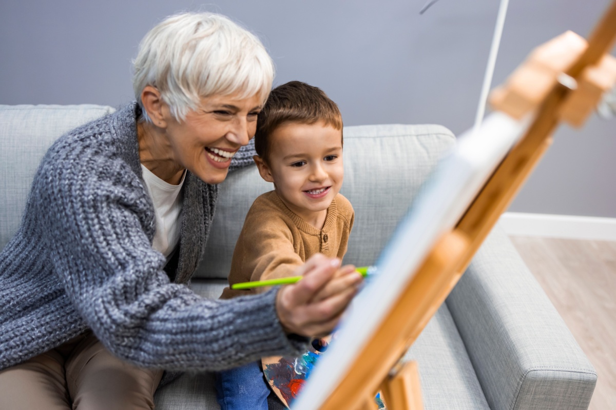 grandma and child paiting together