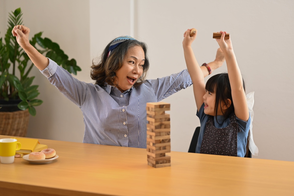 grandmom and grandchild playing board game