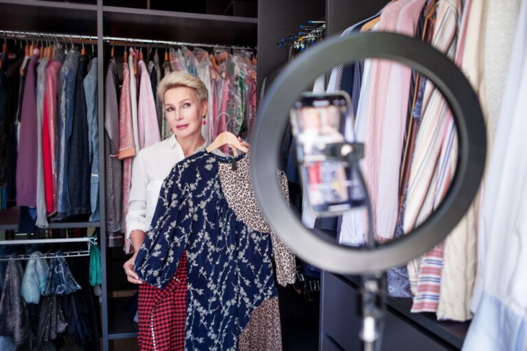 midlife woman showing a dress to a camera