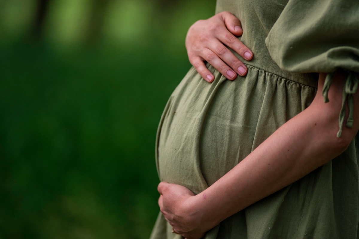 pregnant woman with her hands in her belly