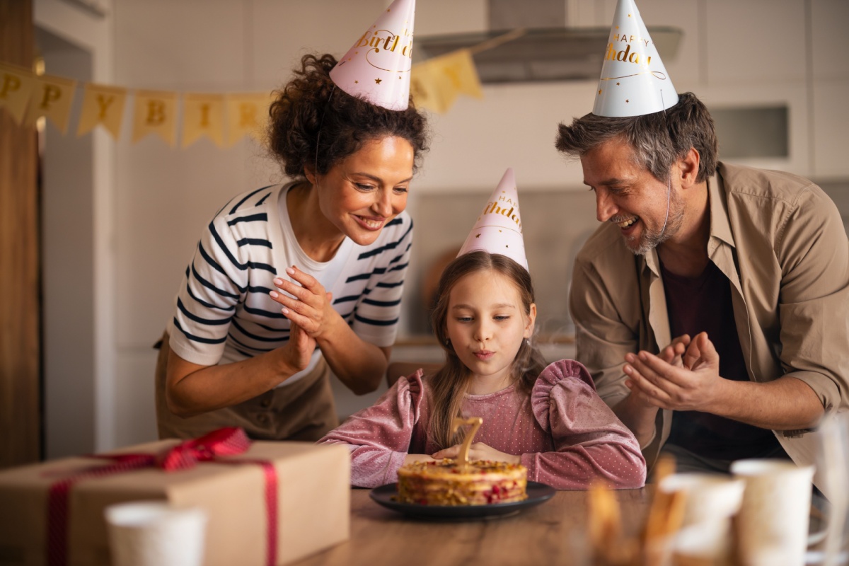 parents and daughter celebrating her birthday