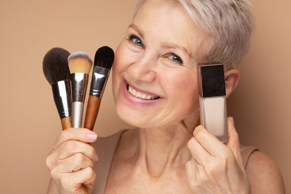 woman holding make up and brushes