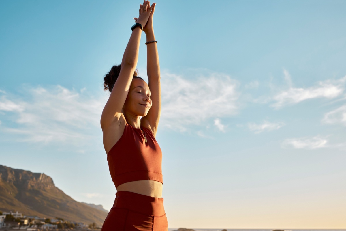 woman practicing yoga outdoors