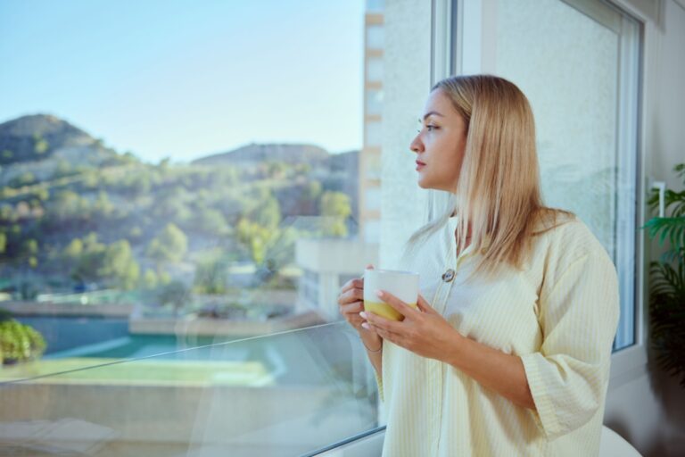 woman looking through a window