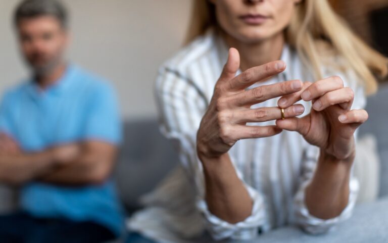 a woman removing her wedding ring