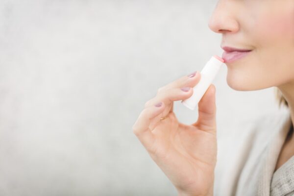 Woman applying chapstick