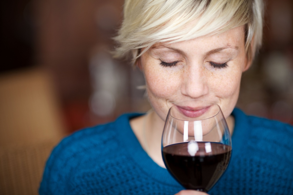 woman smelling a glass of wine