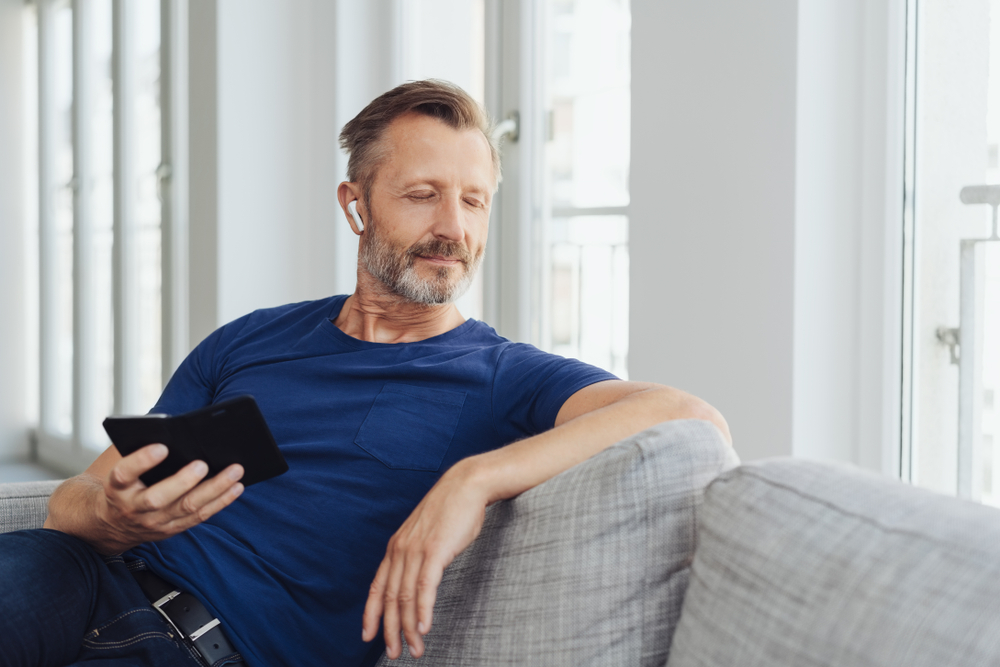 Middle aged man listening to music