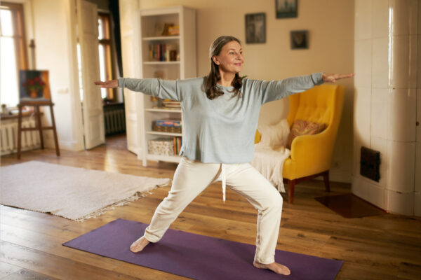 Woman practicing yoga at home