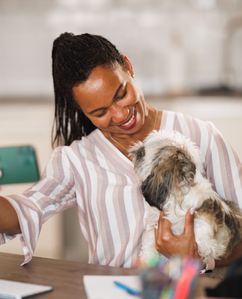 African American woman holding a puppy