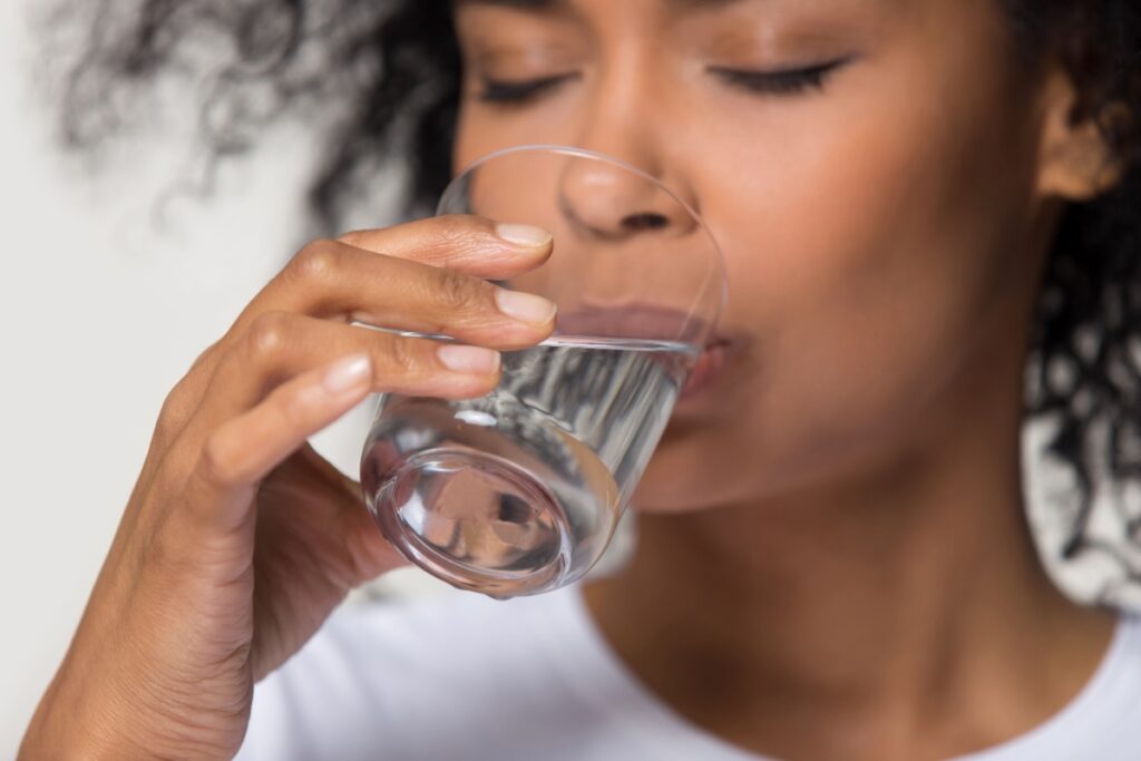 African American woman drinking water