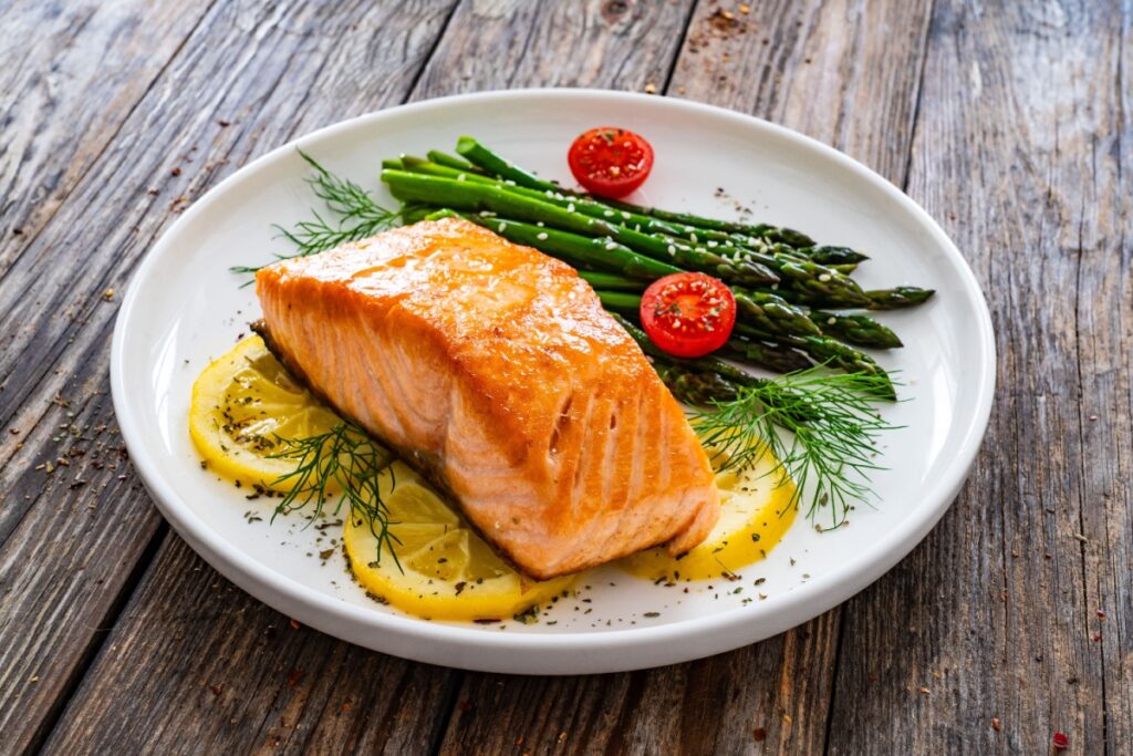 Salmon, lemon and asparagus on a plate
