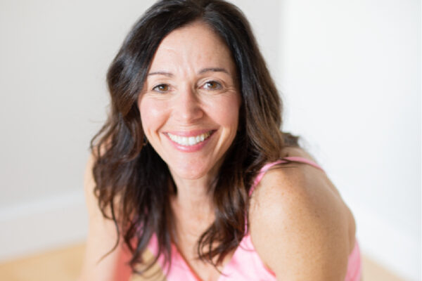 Smiling midlife woman with pink yoga outfit