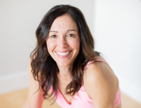 Smiling midlife woman with pink yoga outfit