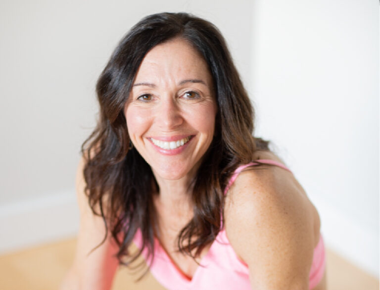 Smiling midlife woman with pink yoga outfit